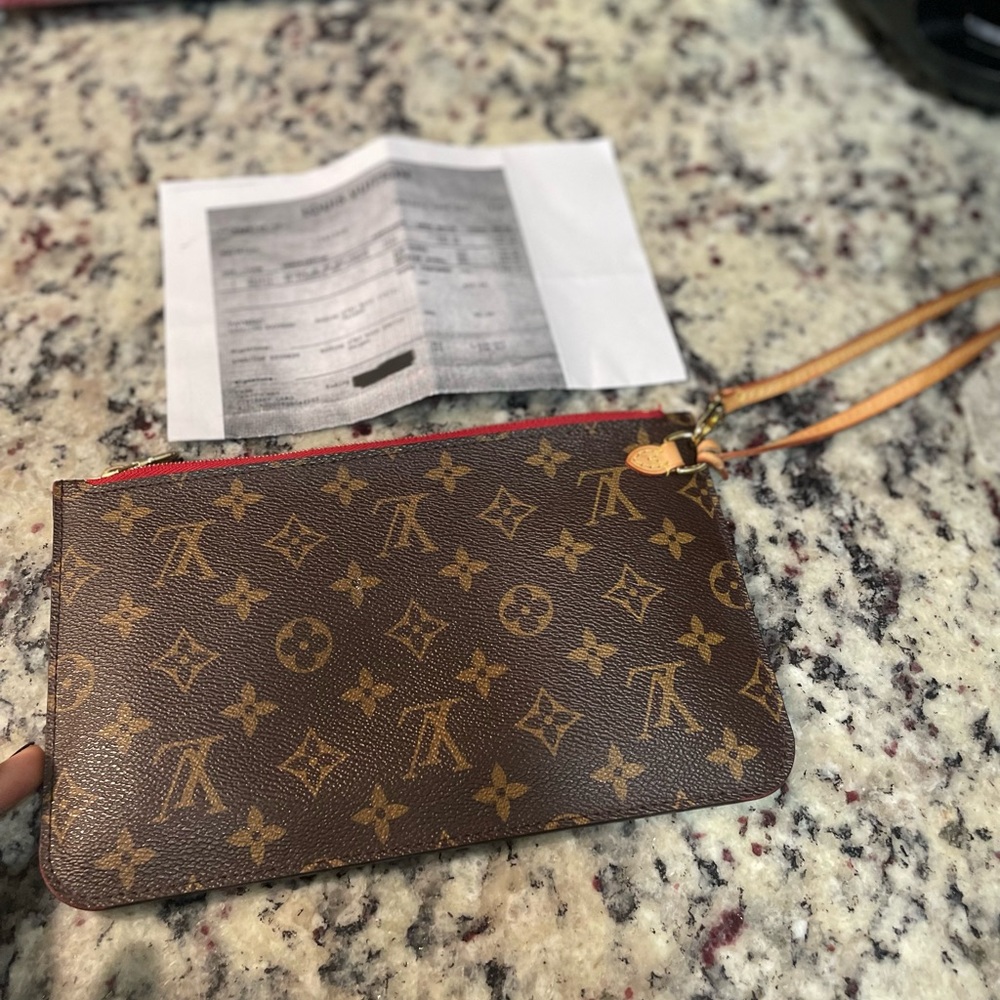 Authentic MM neverfull clutch…LIKE NEW literally nothing is wrong with it